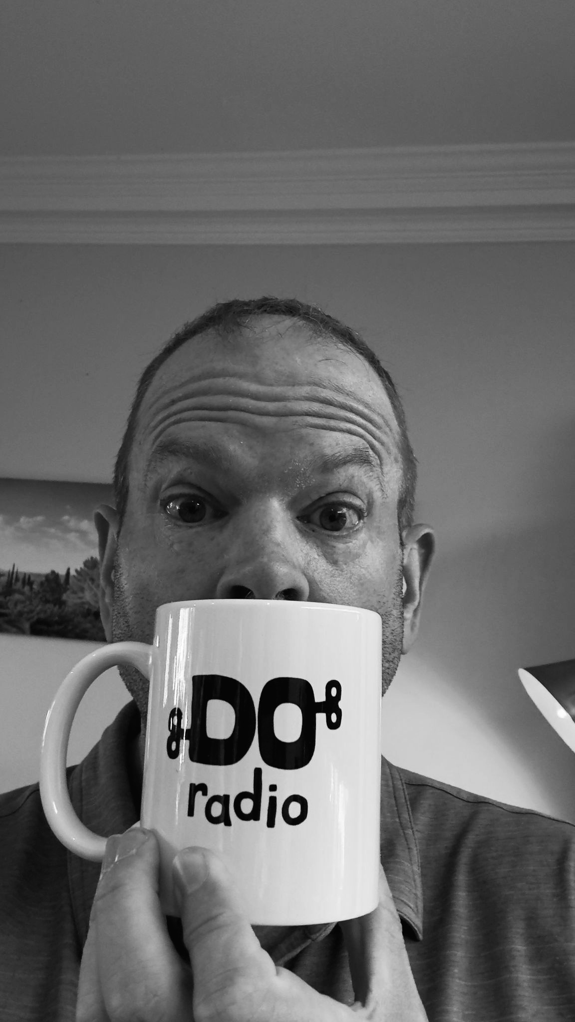 Jon Kaye holding a Do Radio mug